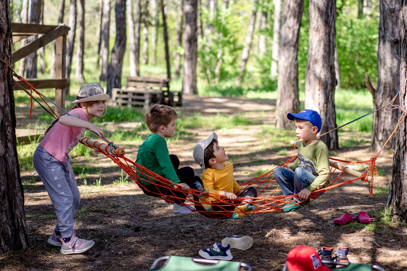 Camp group mid-activity in the woods, big smiles