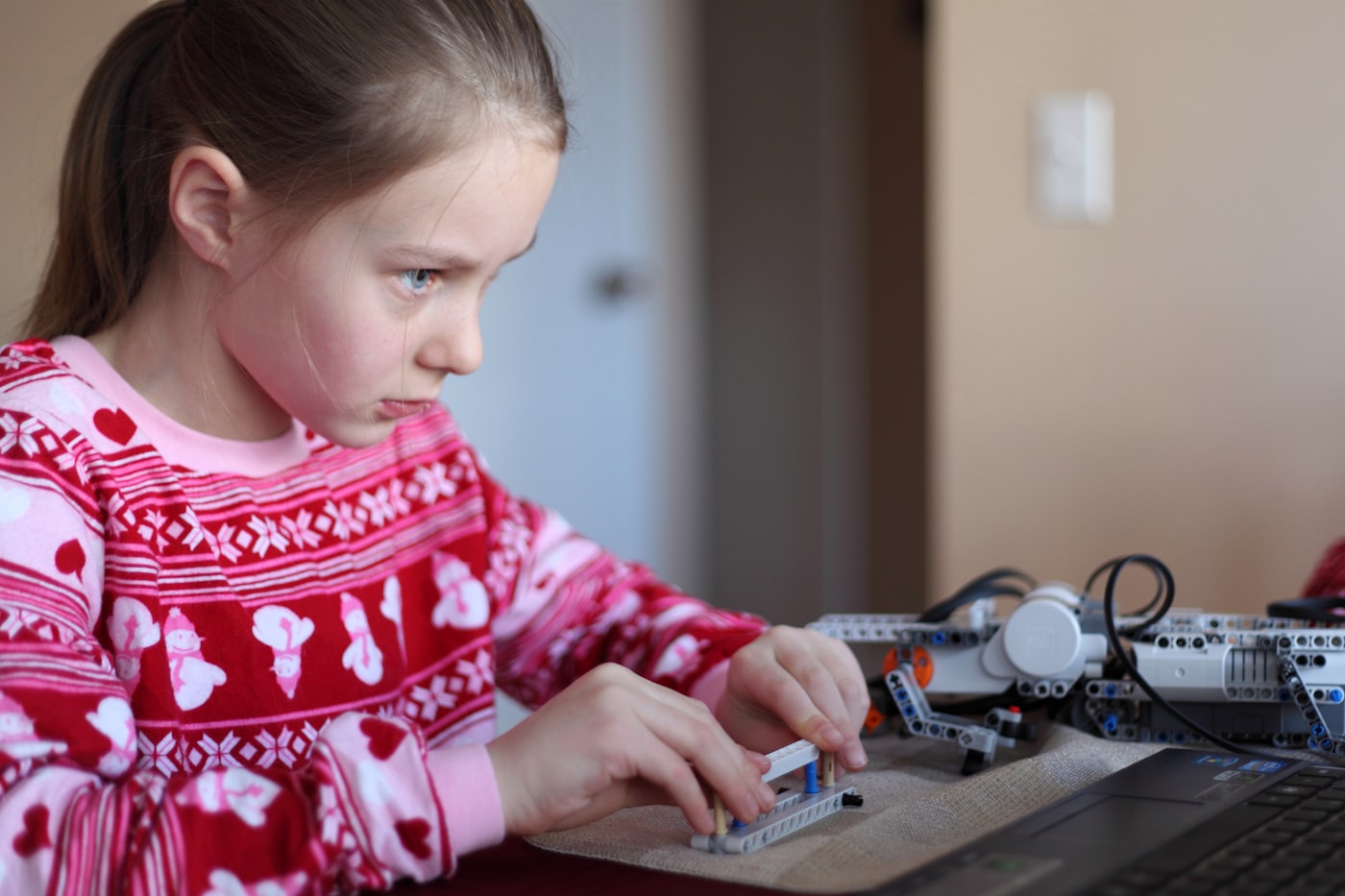 Camper concentrating while building a construction toy robot