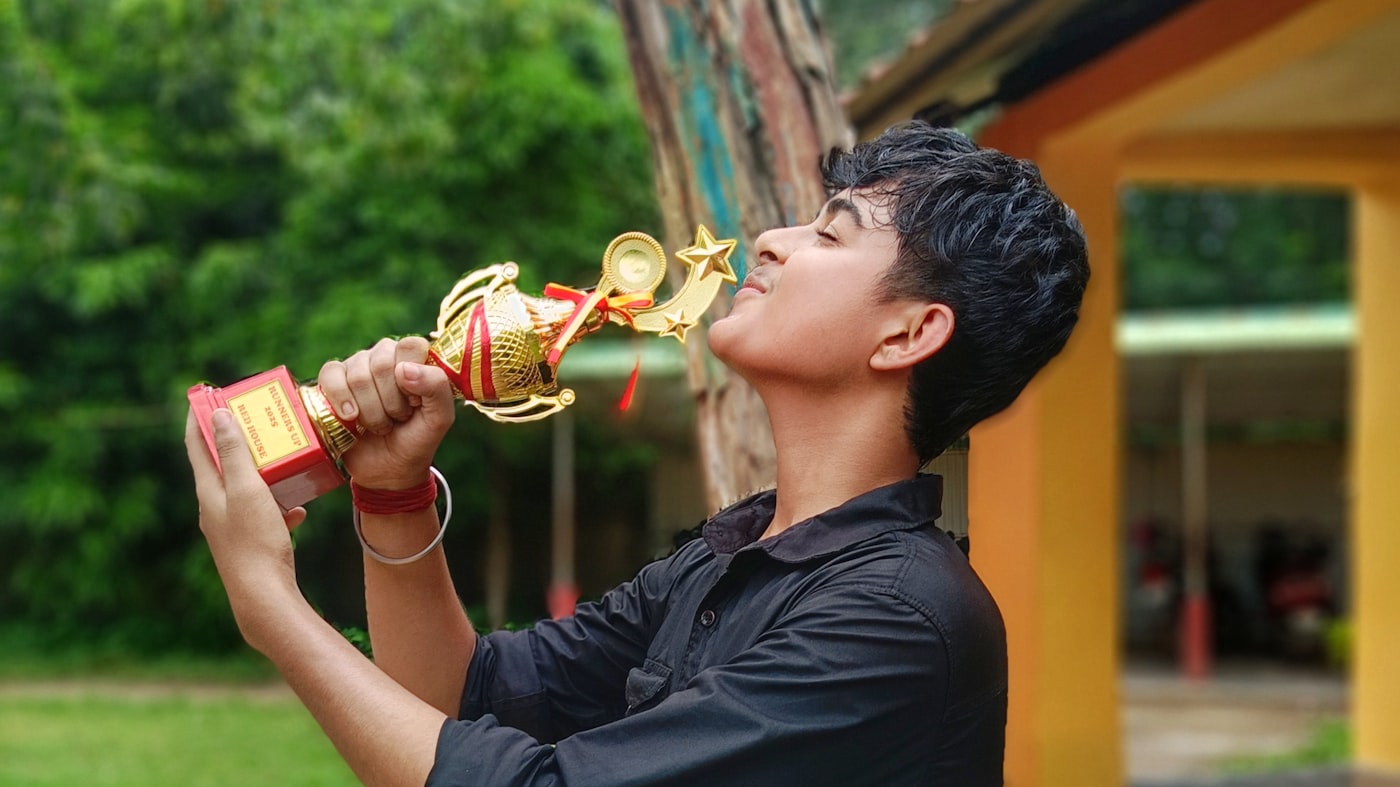 Child holding a trophy with pride