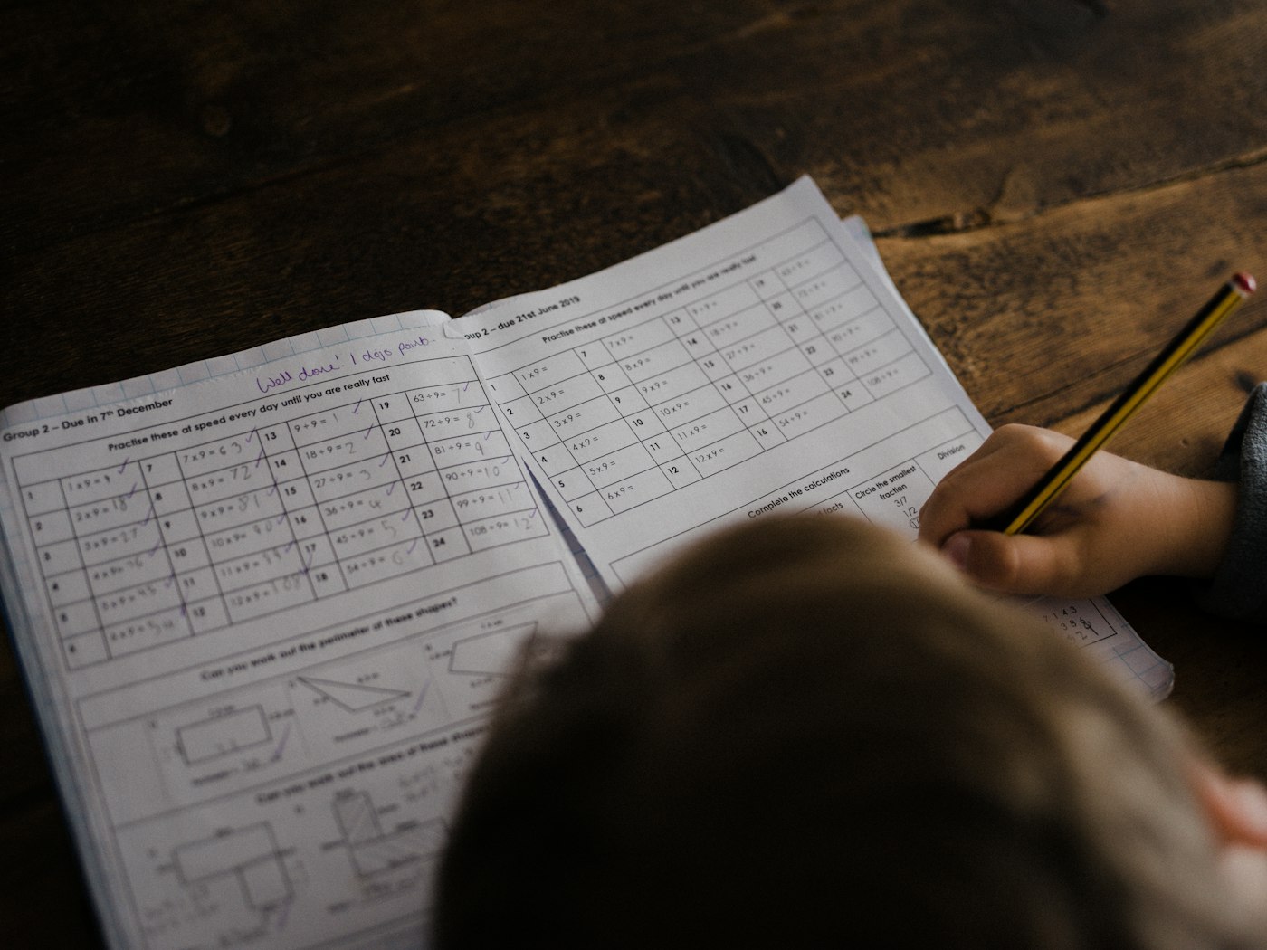 Vedic maths speed practice, boy writing at his desk