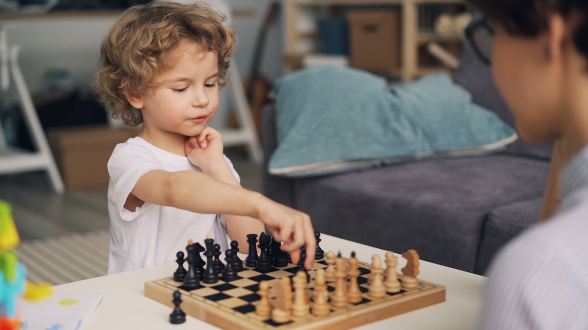 Young boy playing chess, full board in colour and in focus