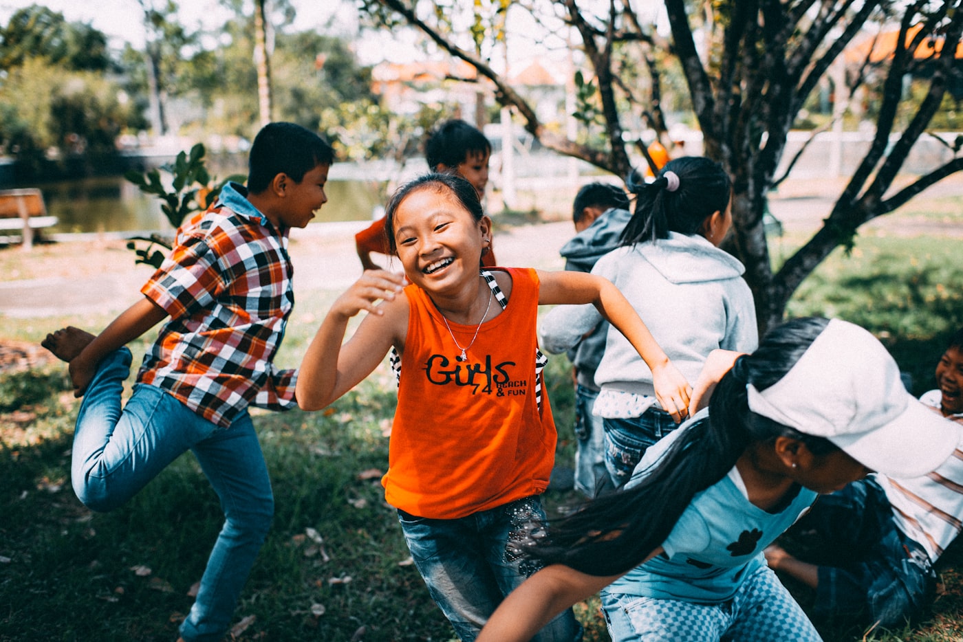 Camper running and laughing during a group activity
