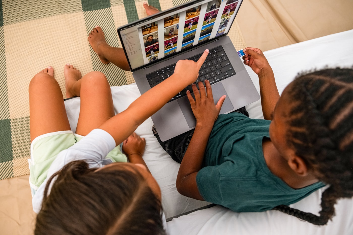Two teammates debugging code together on a laptop