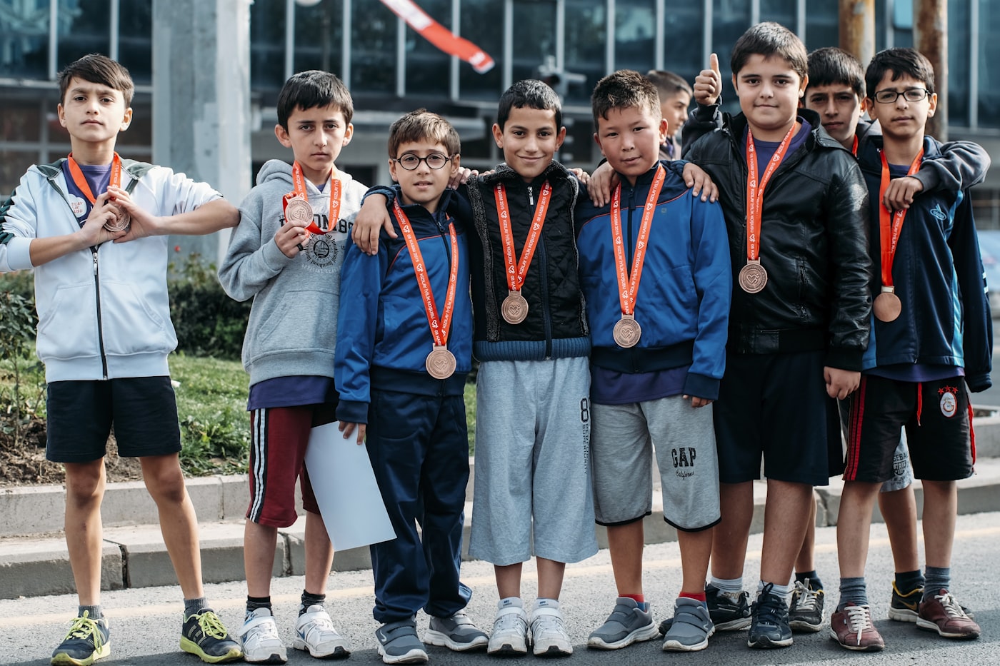 Robotics team of young competitors wearing winner medals