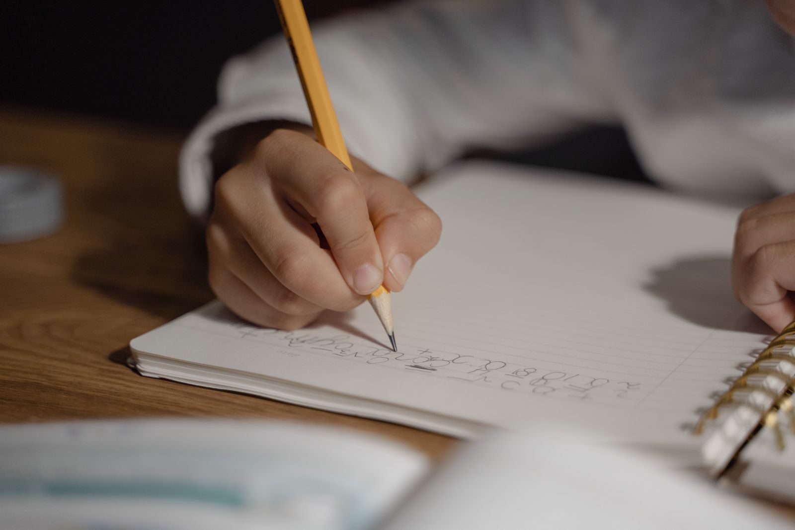 Pencil writing practice close-up in a notebook