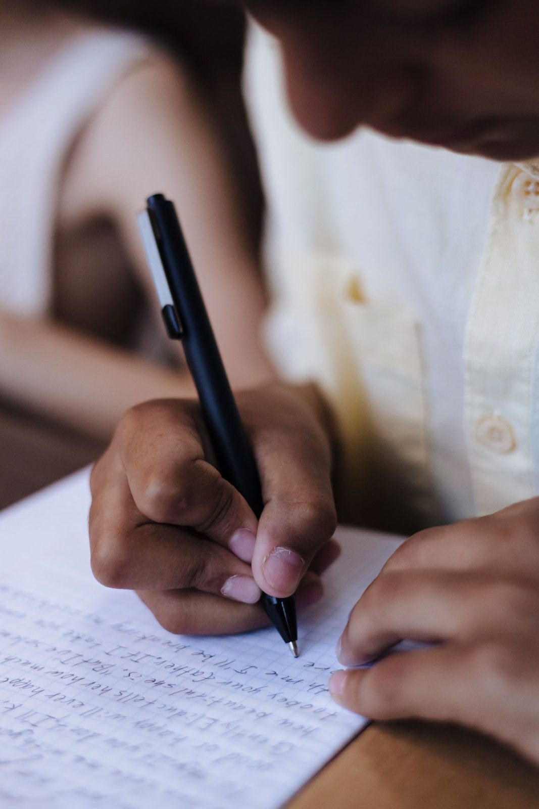 Child practising careful handwriting on paper