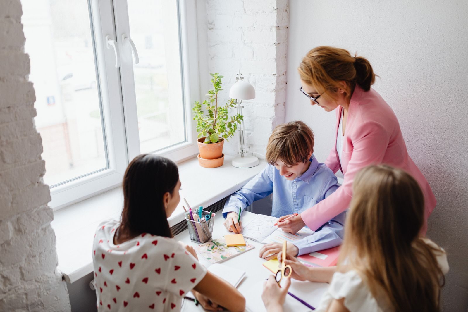 Teacher working with a small group of students at a table