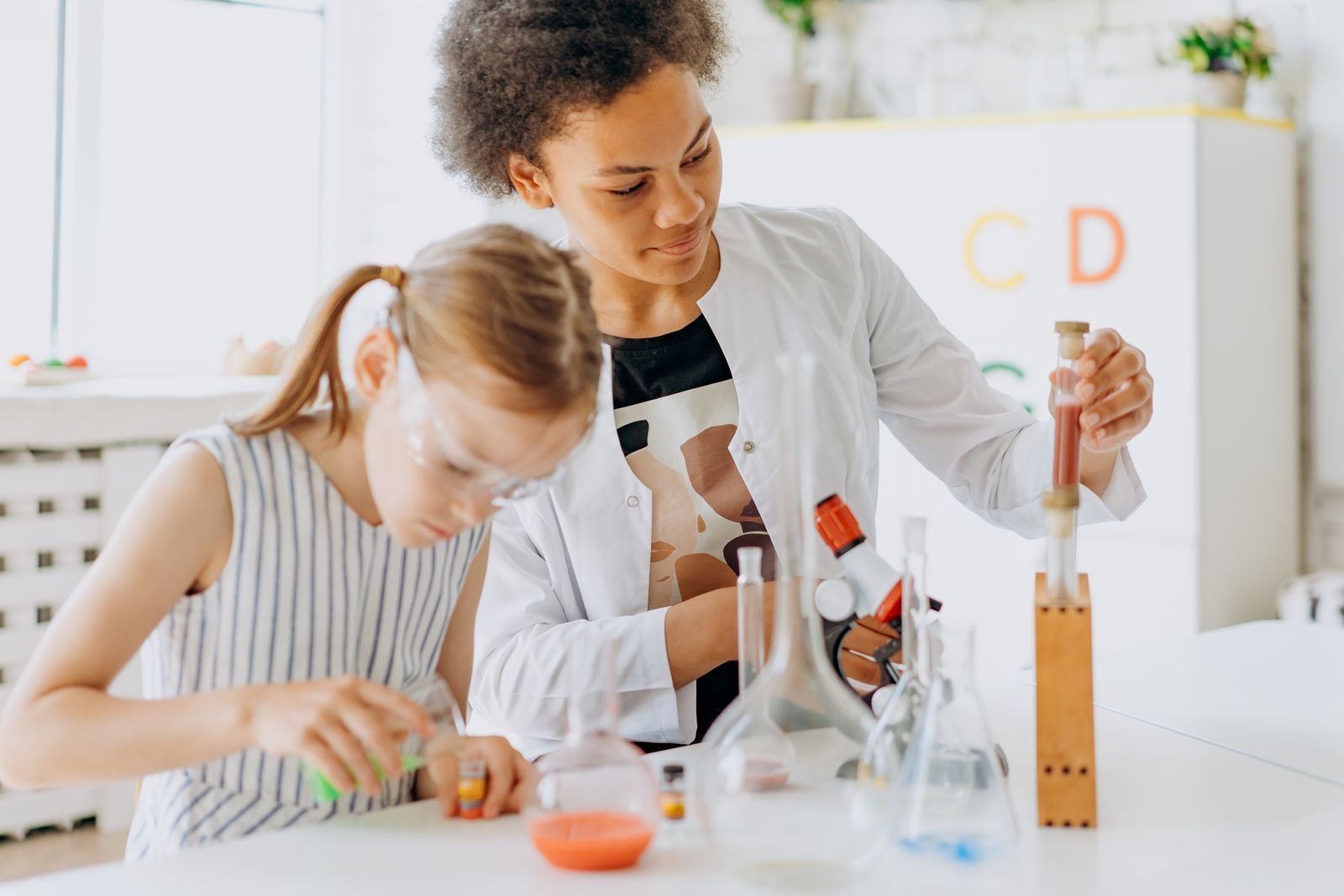 Teacher and students running a chemistry experiment in class